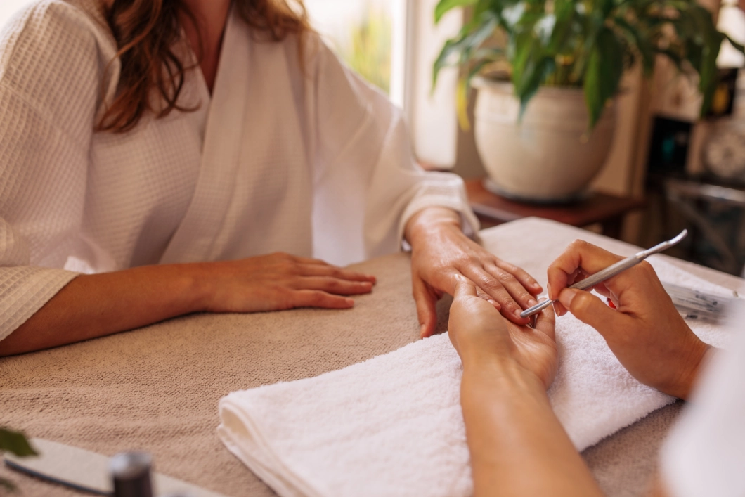 Woman receiving a manicure at spa.